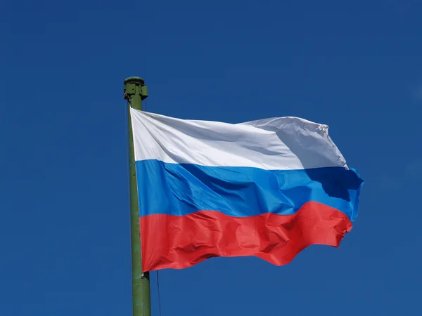 Flag of Russia against the blue sky — Stock Photo, Image