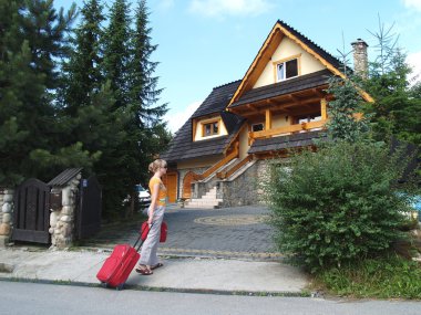 The tourist goes to a country house to Zakopane, Poland clipart