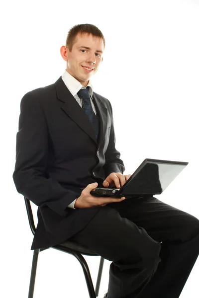 stock image The businessman on the chair with laptop