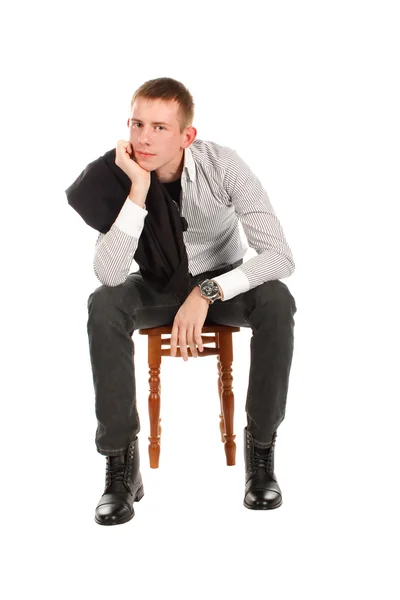 Man sitting on a chair against a white background — Stock Photo, Image