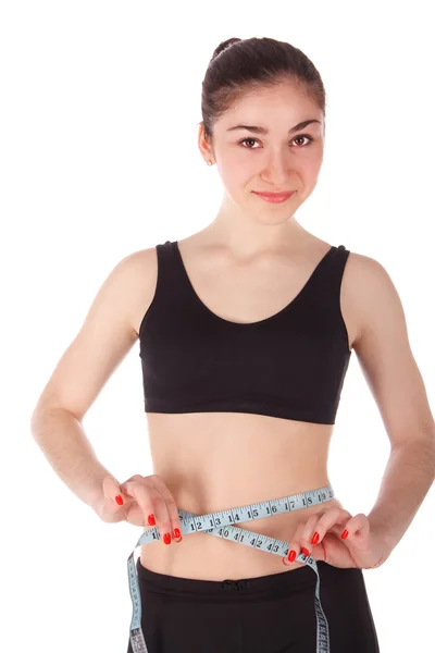 Mujer fitness midiendo su cintura — Foto de Stock