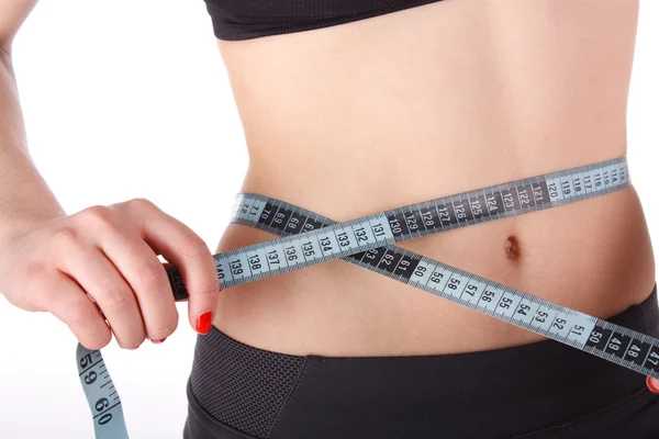 Mulher fitness medindo sua cintura — Fotografia de Stock