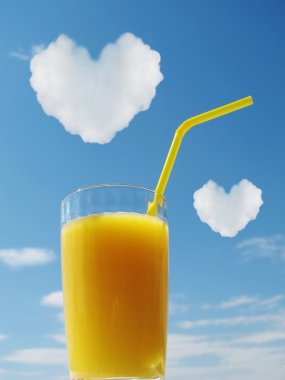 Orange juice and heart on a sky. clipart