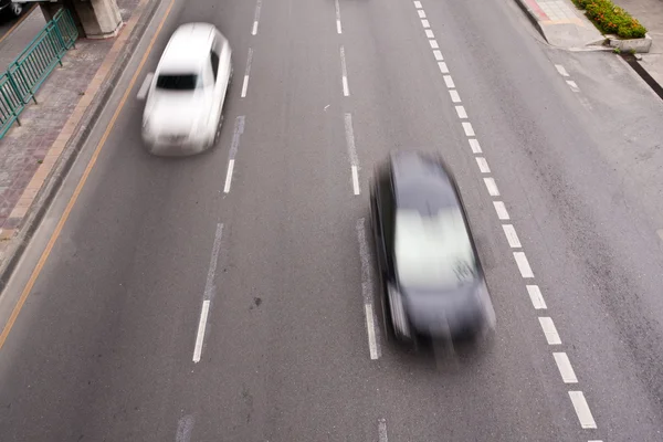 stock image Black and white cars running on the road