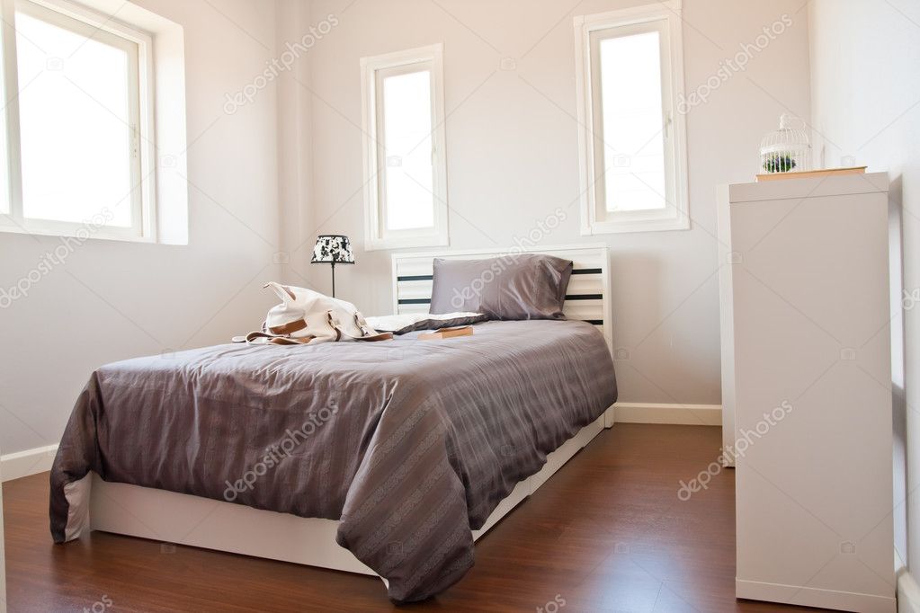 White bedroom with brown sheet bed