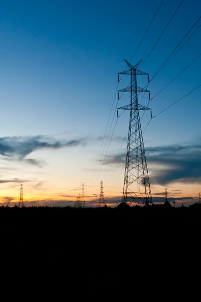 Electricity poles in twilight time — Stock Photo, Image