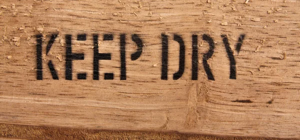 "Keep dry "on wood — стоковое фото
