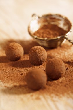 Chocolate truffles cocoa powder dusted and sieve, shallow dof clipart