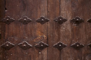 Old wooden door with metal ornate background clipart