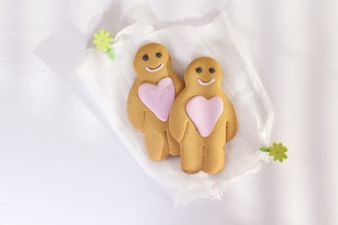 Gingerbread boy and girl under morning sun clipart