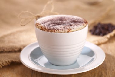 Hot frothy drink cappuccino coffee, rustic style, shallow dof clipart