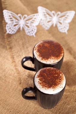 Hot frothy drink cappuccino chokolate dusted, white paper butter clipart