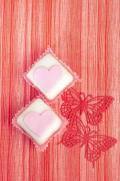 Festive pink cupcakes heart shaped with red butterfly and red s — Stock Photo, Image