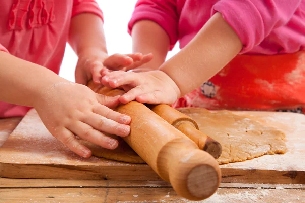 Two little girls with rolling pins baking and having fun — Stock Photo, Image