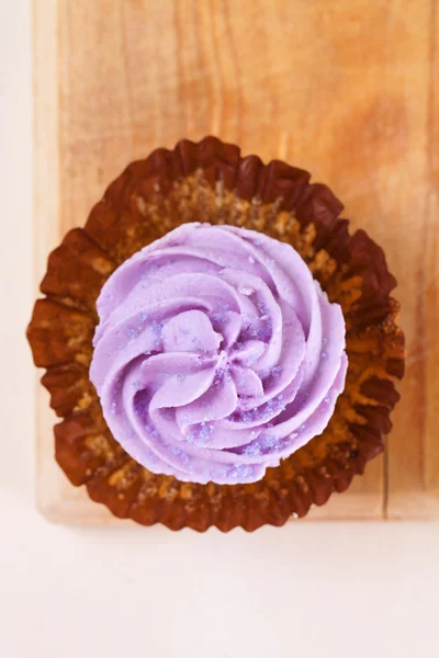 Cupcake with lavender top unwrapped — Stock Photo, Image