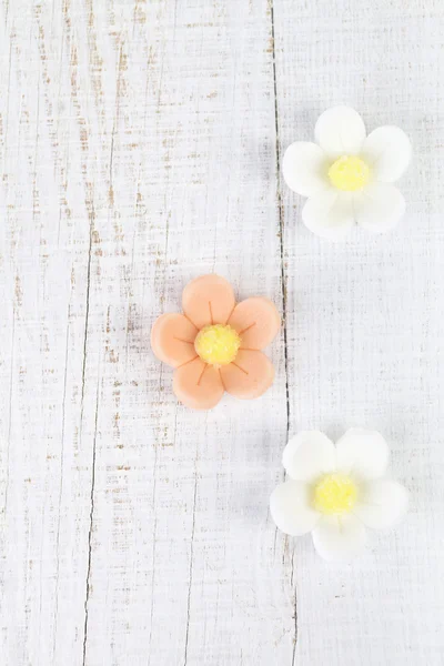 Three sugar blossom flowers on white old table — Stock Photo, Image