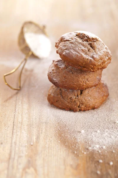 Soft ginger cookies three stacked and dusted on wooden table — Stock Photo, Image