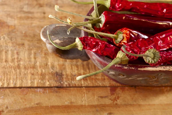 Dried red hot chillies pepper in old wooden bowl — Stock Photo, Image