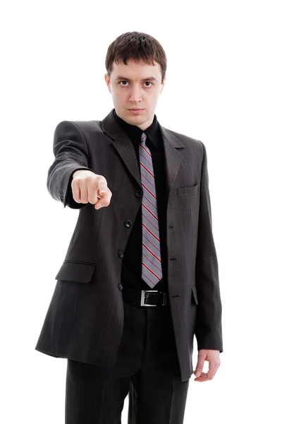 Młody człowiek w garniturze, wskazuje palcem. — Zdjęcie stockowe