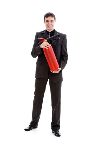 Joven y sonriente hombre con traje que sostiene un extintor de incendios . — Foto de Stock