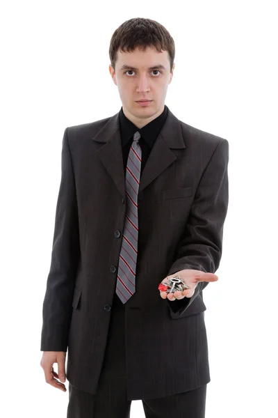 Young man in a suit, offering the keys. — Stock Photo, Image