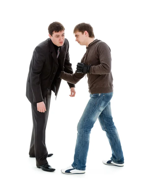 A young man knocks out a businessman. — Stock Photo, Image