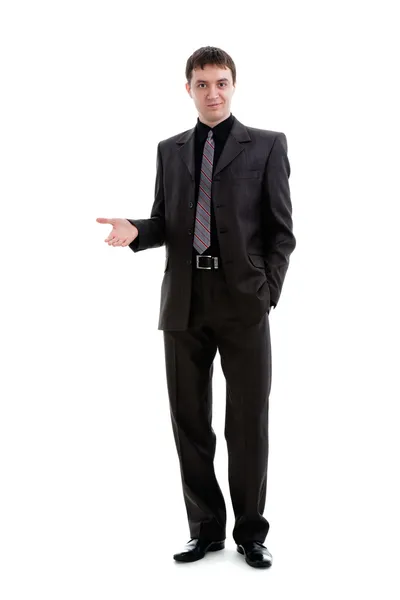 A young man in a suit shows his hand to the side. — Stock Photo, Image
