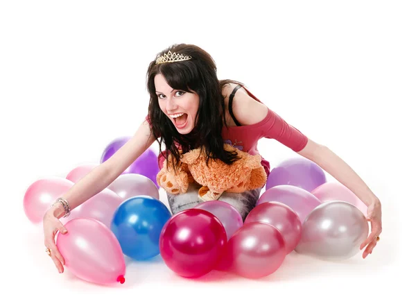 Молодая сексуальная женщина сидит среди воздушных шаров с плюшевым мишкой . — стоковое фото