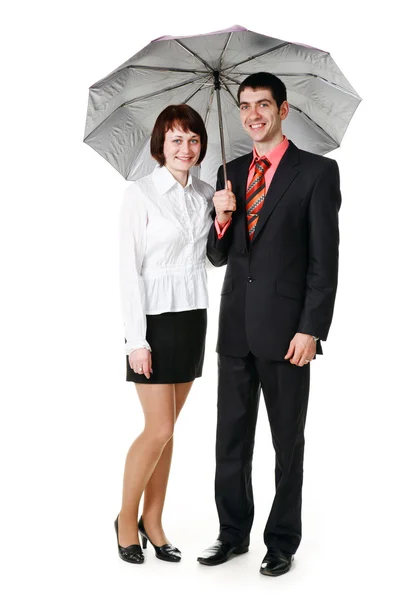 Young man and woman standing under an umbrella. — Stock Photo, Image