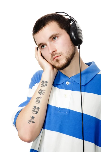 Young guy with a beard, headphones. — Stock Photo, Image
