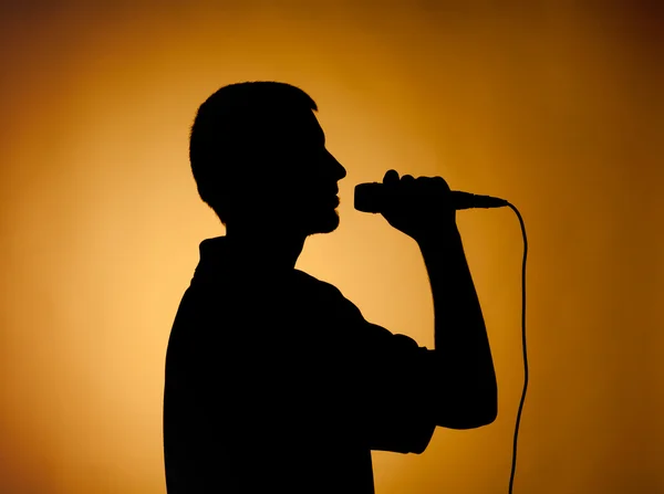 Silhouette of a young man in orange. — Stock Photo, Image