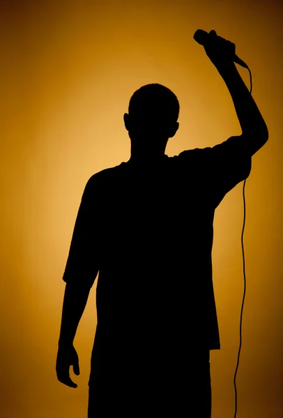 Silhouette of a young man in orange. — Stock Photo, Image