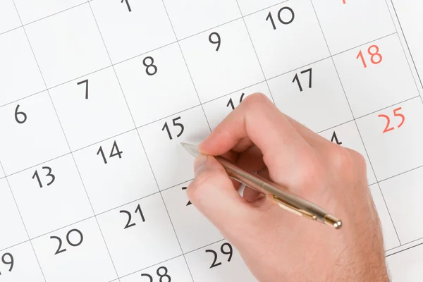 Mão escrever no calendário — Fotografia de Stock