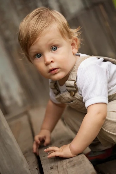 Kid on the wooden porch. — Stock Photo, Image