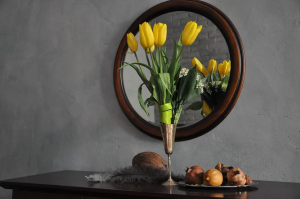 Yellow tulips with fruits near the mirror — Stock Photo, Image