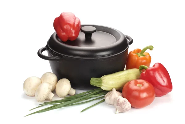 Black cast-iron cauldron with vegetables — Stock Photo, Image