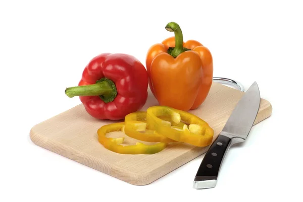 Colorful peppers on board — Stock Photo, Image