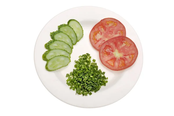 Sliced tomato, cucumber and green onion on white plate — Stock Photo, Image