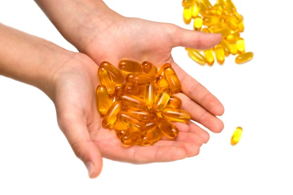 Isolated pill gel supplement capsules on hand, macro — Stock Photo, Image