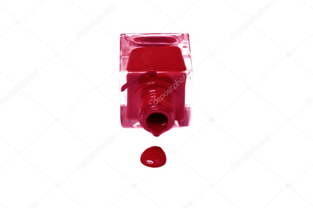 Red nail polish bottle with splatters isolated on white backgrou