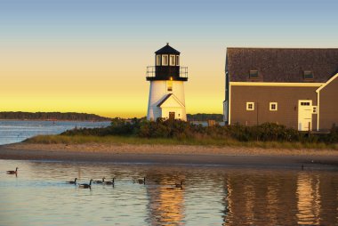 Hyannis harbor lighthouse at sunset clipart