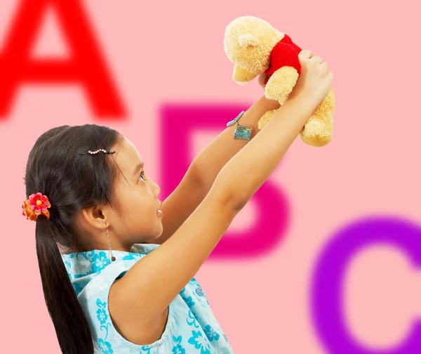 Girl Holding Her Teddy Bear Up In The Air — Stock Photo, Image