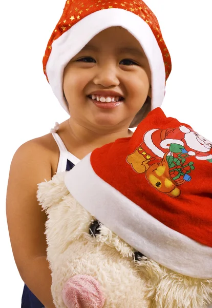 Молода дівчина і м'яка іграшка носіння Санта капелюхів — стокове фото