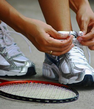 Tying Shoe Laces Ready For A Game Of Badminton clipart