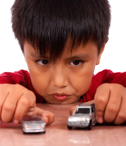Boy Playing With Toy Cars On A Table — Stock Photo, Image