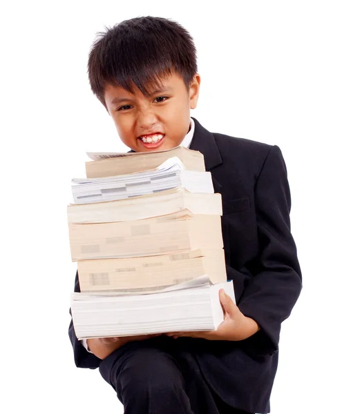 Pojke med massor av läxor bär böcker — Stockfoto