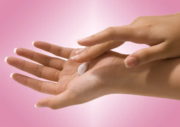 Putting Hand Cream On Her Hands — Stock Photo, Image