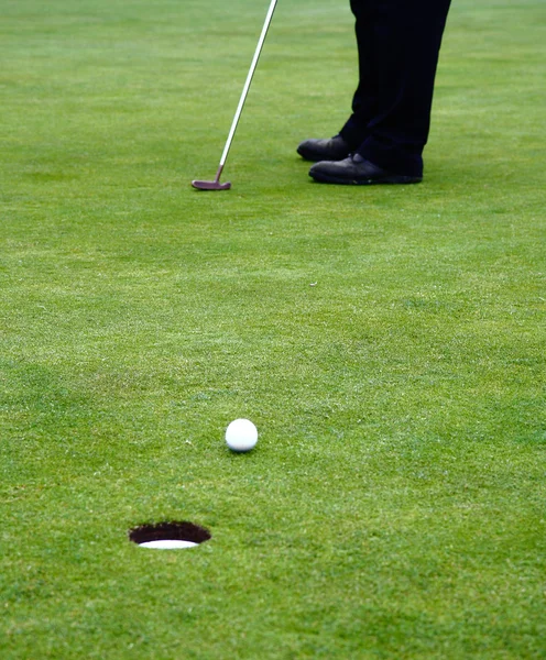 Мяч для гольфа на зеленой дорожке — стоковое фото