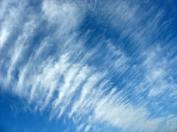 Blauwe hemelachtergrond met wollige wolken — Stockfoto