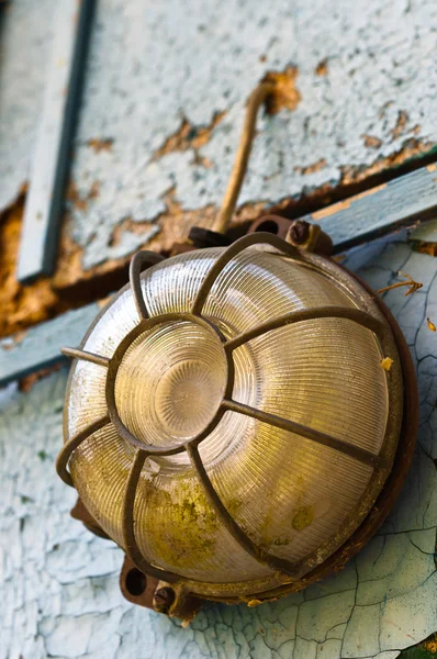 Old and dirty lamp on blue abandoned wall — Stock Photo, Image